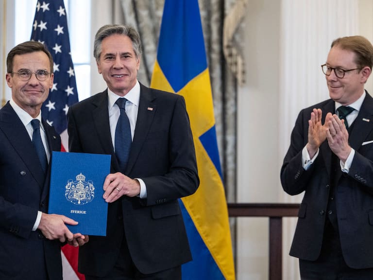 US Secretary of State Antony Blinken receives the NATO ratification documents from Swedish Prime Minister Ulf Kristersson, as Swedish Foreign Minister Tobias Billstrom applauds, during a ceremony at the US State Department, as Sweden formally joins the North Atlantic alliance, in Washington, DC, on March 7, 2024. Kristersson hailed his country&#039;s entry into NATO as a &quot;victory for freedom,&quot; as it turned the page on two centuries of non-alignment following Russia&#039;s invasion of Ukraine. The accession &quot;is a victory for freedom today. Sweden has made a free, democratic, sovereign and united choice to join NATO,&quot; he said at the ceremony. (Photo by ANDREW CABALLERO-REYNOLDS / AFP) (Photo by ANDREW CABALLERO-REYNOLDS/AFP via Getty Images)