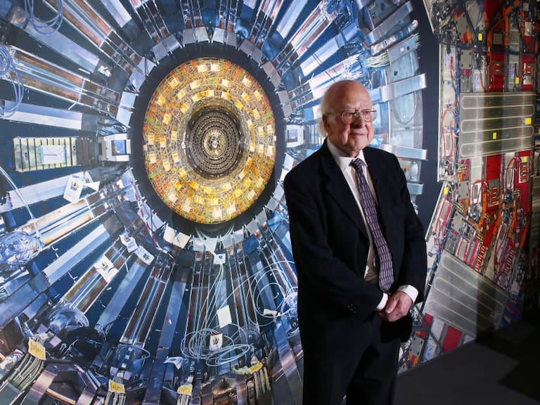LONDON, ENGLAND - NOVEMBER 12:  Professor Peter Higgs stands in front of a photograph of the Large Hadron Collider at the  Science Museum&#039;s &#039;Collider&#039; exhibition on November 12, 2013 in London, England. At the exhibition, which opens to the public on November 13, 2013  visitors will see a theatre, video and sound art installation and artefacts from the Large Hadron Collider, providing a behind-the-scenes look at the CERN particle physics laboratory in Geneva. It touches on the discovery of the Higgs boson, or God particle, the realisation of scientist Peter Higgs theory.  (Photo by Peter Macdiarmid/Getty Images)